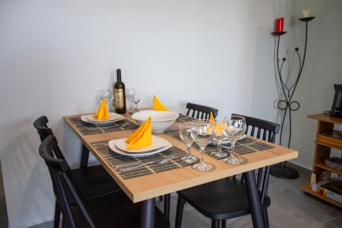 a dining room table with plates and wine glasses at Kolymvari Hills in Chania Town