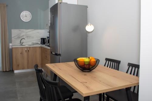 a kitchen with a wooden table with a bowl of fruit at Kolymvari Hills in Chania Town