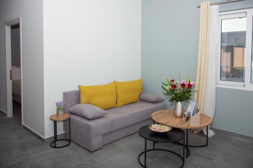 a living room with a couch and two tables at Kolymvari Hills in Chania Town