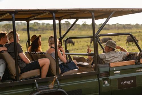 a group of people riding in a safari vehicle at Makweti Safari Lodge in Welgevonden Game Reserve