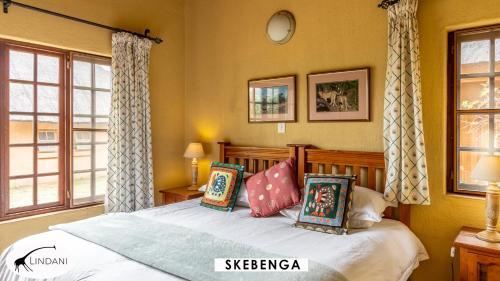 a bedroom with a bed with pillows on it at Lindani Game and Lodges in Vaalwater