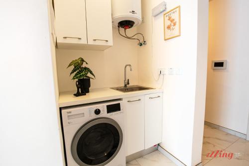 a kitchen with a washing machine and a sink at Mensija Valley Residences in St Julian's