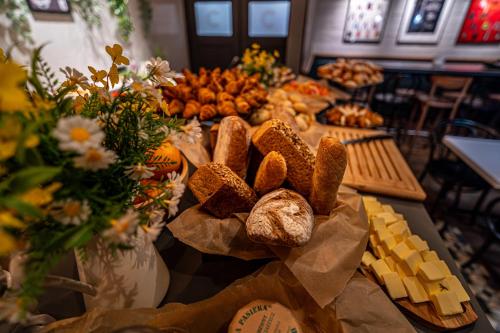 a table with bread and cheese and other foods at Ibis Szczecin Centrum in Szczecin