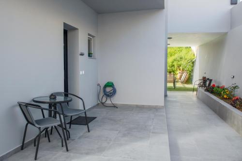 a hallway with a table and chairs in a house at Kolymvari Hills in Chania Town