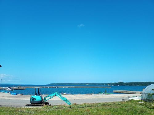 a beach with a slide on the side of the water at 能登島ゲストハウスうたたね in Nanao