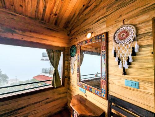 a corner of a room with a mirror and a window at Cloudwalks Homestay in Kodaikānāl