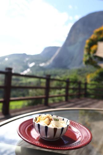 a bowl of food on a plate on a table at Aldeia Flor de Liz - Pedra Azul in Pedra Azul