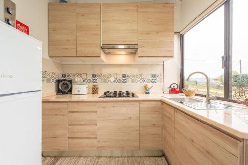 a kitchen with wooden cabinets and a sink at Countryside paradise in Bucelas in Bucelas