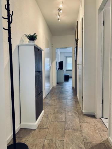 a hallway of an office with a tile floor at FeWo Am Hang mit Balkon im Grünen in Bad Bentheim