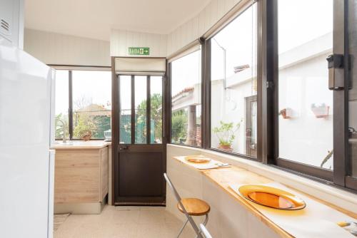 a kitchen with windows and a counter with a sink at Countryside paradise in Bucelas in Bucelas