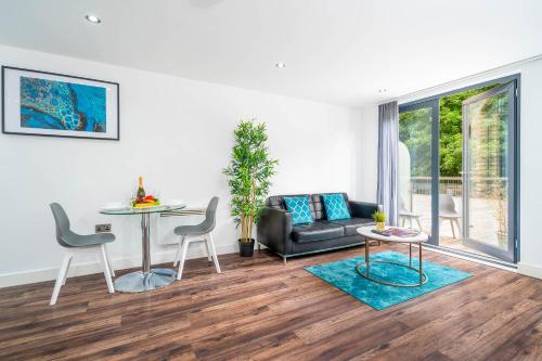 a living room with a table and a couch at Fabulous Birmingham City Centre 2 Bedroom Apartment - Private Terrace - Top Rated - 004H in Birmingham