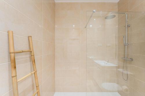 a bathroom with a shower with a glass door at GuestReady - Casas de Fralães in Barcelos