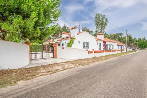 a house on the side of a street at Refreshing poolside escape in Ponte de Sor in Ponte de Sor