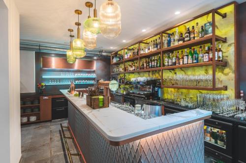 a bar with a counter with a lot of drinks at Parkhotel Flora in Bad Grund