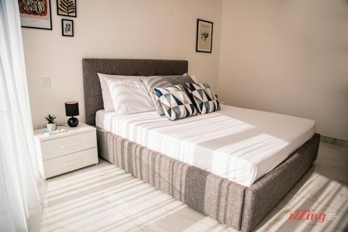 a bedroom with a bed with a nightstand and a bed sidx sidx at Mensija Valley Residences in St Julian's