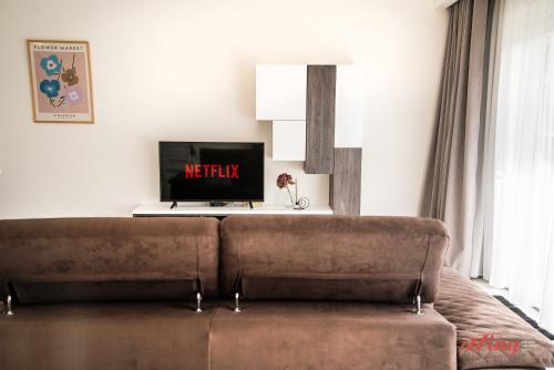 a living room with a couch and a tv at Mensija Valley Residences in St Julian's