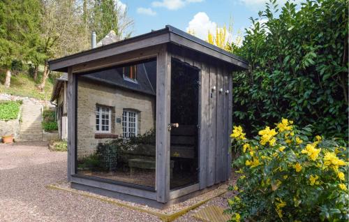 a wooden greenhouse in a garden with flowers at Stunning Home In Stmarguerite Dloges in Sainte-Marguerite-des-Loges