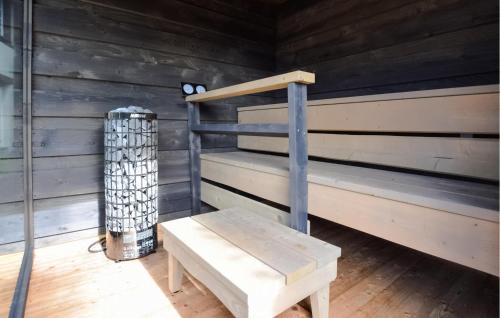 a wooden cabin with a bench in a room at Stunning Home In Stmarguerite Dloges in Sainte-Marguerite-des-Loges