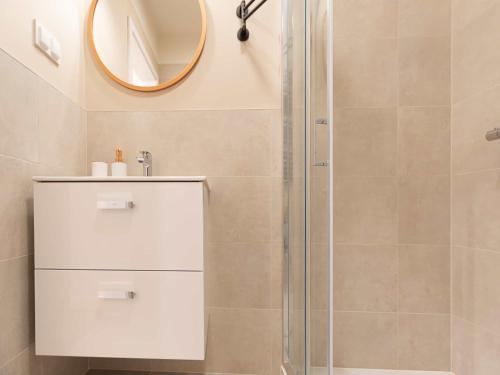 a bathroom with a shower and a mirror at VacationClub - Apartamenty Zakopiańskie Apartament 34 in Zakopane