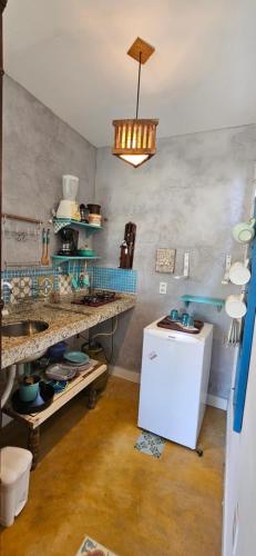 a kitchen with a sink and a counter top at Kite Nômade in Arraial do Cabo
