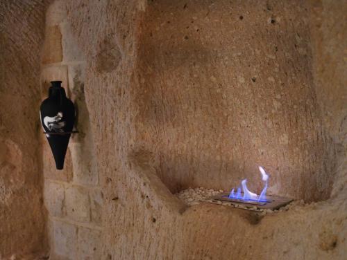a stone wall with a fire place in a wall at Very Peri Cappadocia - The Lifestyle Luxury Design Hotel in Uchisar