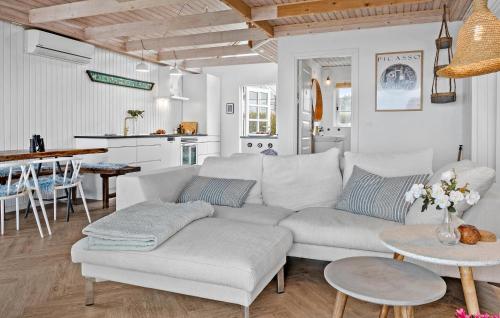 a living room with a couch and a table at 2 Bedroom Cozy Home In Sjølund in Sjølund