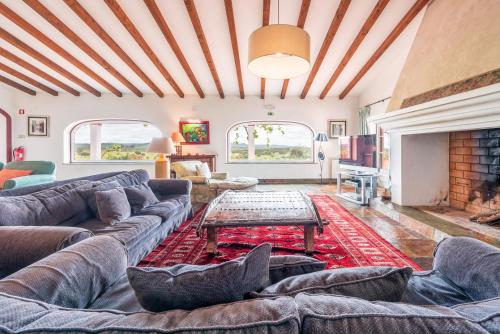 un salon avec un canapé et une cheminée dans l'établissement Stunning mansion in São Cristóvão, à Montemor-o-Novo