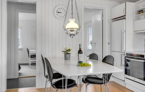 a white kitchen with a white table and chairs at Nice Home In Haderslev With Wifi in Haderslev