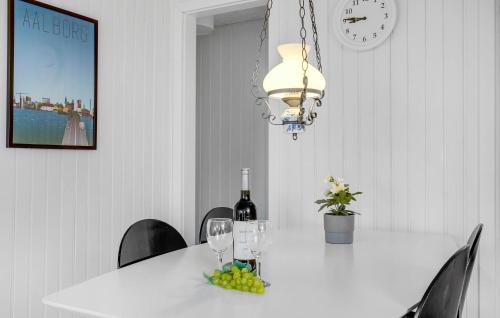 a dining room table with wine glasses and a chandelier at Nice Home In Haderslev With Wifi in Haderslev