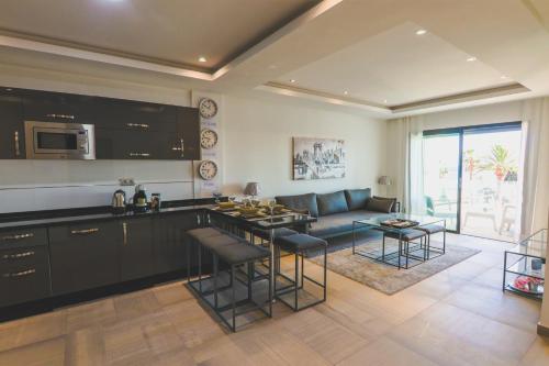 uma cozinha e sala de estar com um sofá e uma mesa em Dassine View - Luxe - Agadir - 5 Px em Agadir