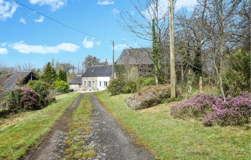 a dirt road in a field with a house at Gorgeous Home In Passais-Villages in Saint-Siméon
