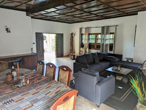 a living room with a couch and a table at ROMO house in Cotonou