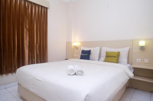 Ένα ή περισσότερα κρεβάτια σε δωμάτιο στο Urbanview Hotel Pondok Anggun Yogyakarta by RedDoorz