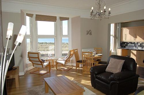 a living room with a couch and a table at Abermaw Sea View Apartment in Barmouth