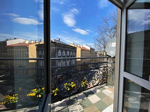 a view from a window of a balcony with flowers at Apartament Familijny in Przemyśl