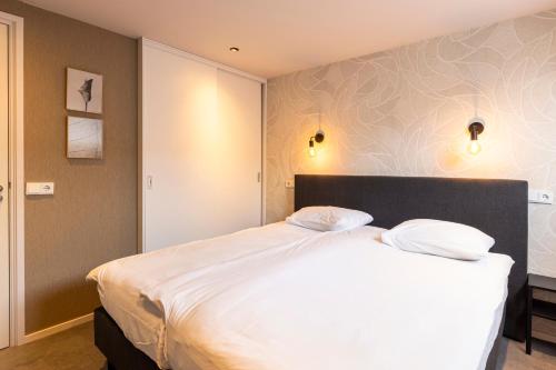 Una cama o camas en una habitación de Weeruusz