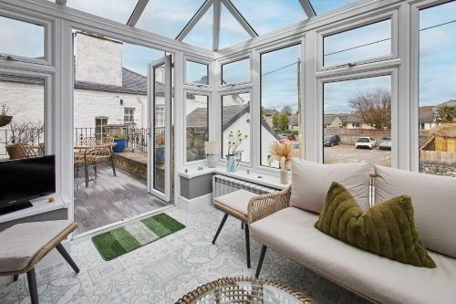 a living room with a lot of windows at Host & Stay - Lime Tree House in Holme