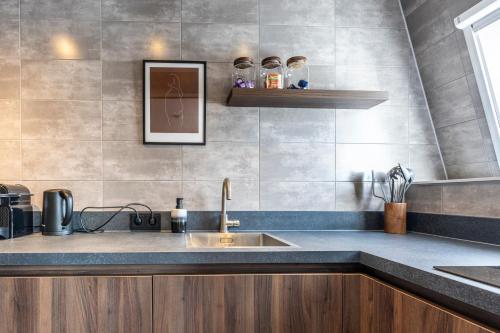 a kitchen with a sink and a counter top at Weeruusz in Kolderwolde