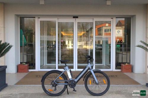 a bike parked in front of a building at Toscana Charme Resort in Tirrenia