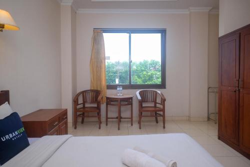 Ένα ή περισσότερα κρεβάτια σε δωμάτιο στο Urbanview Hotel Pondok Anggun Yogyakarta by RedDoorz