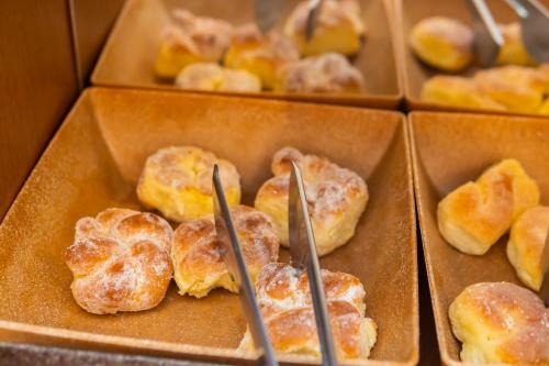 a box of donuts with two sticks in it at Hotel Colonial in São Lourenço