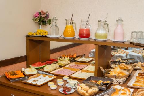 a table filled with different types of food and drinks at Hotel Colonial in São Lourenço