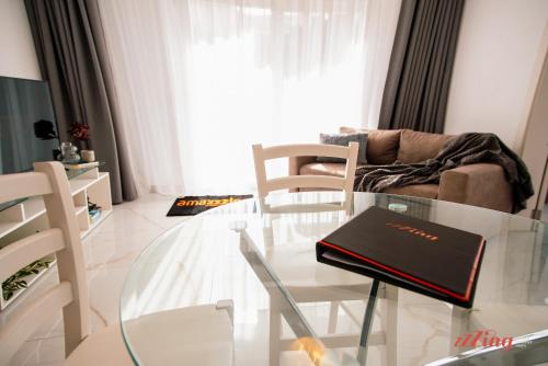 a living room with a glass table and chairs at Mensija Valley Residences in St Julian's