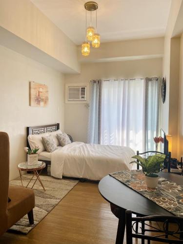 a bedroom with a bed and a table in it at The Loop Studio at 5th floor Limketkai Mall infront Atrium Lucky 11 in Cagayan de Oro