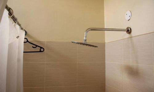 a bathroom with a shower with a shower head at LIA Hotel & Training Centre in Nairobi