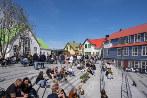 a crowd of people sitting on the street in a town at Hotel Selfoss in Selfoss