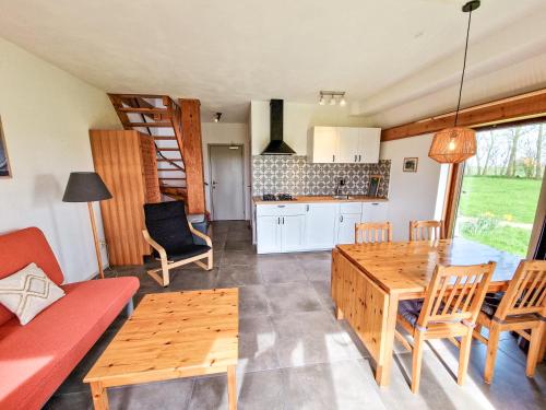 a kitchen and living room with a table and chairs at De Gelukskever renovated 2024 in Hindeloopen