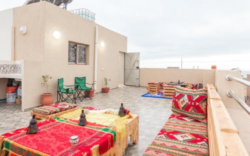 a living room with two beds and two chairs at Imsouane Wave Residences in Imsouane