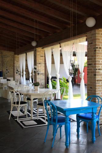 a dining room with blue tables and white chairs at Park Hotel Italia in Tezze sul Brenta