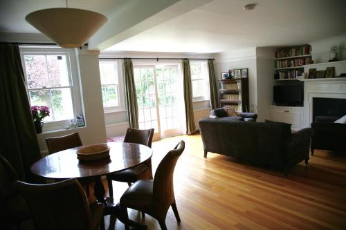a living room with a table and a couch at Garden flat in a quiet Camden spot in London